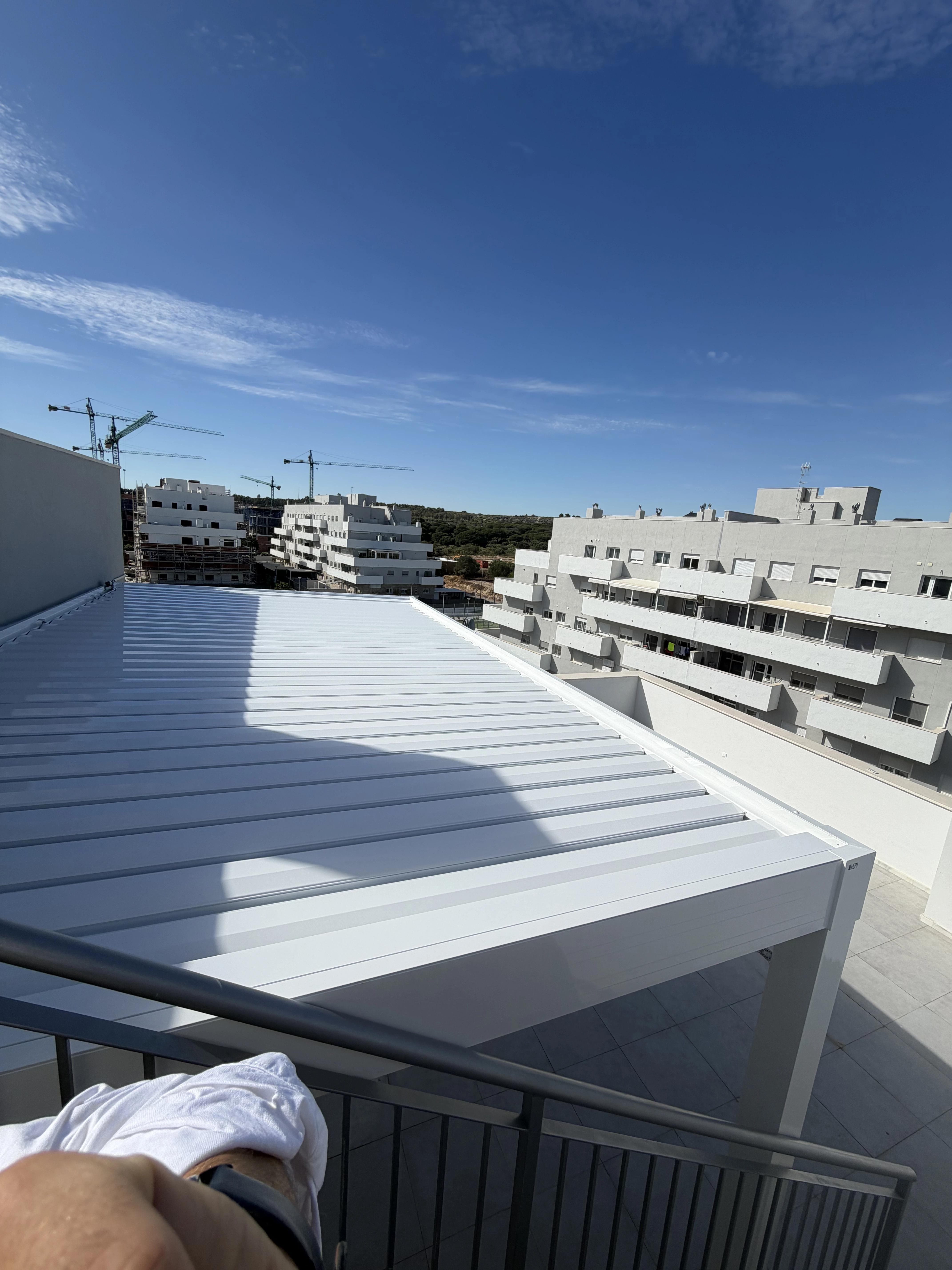 Pérgola bioclimática vista superior con lamas cerradas sobre terraza junto al Atlántico, Conil de la Frontera